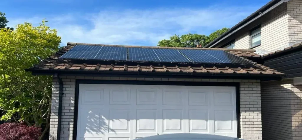 Roof-mounted solar panels on a residential garage maintained by certified solar installers in Stockport
