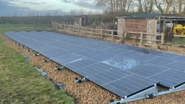 Ground-mounted solar panel system undergoing inspection and maintenance in Greater Manchester