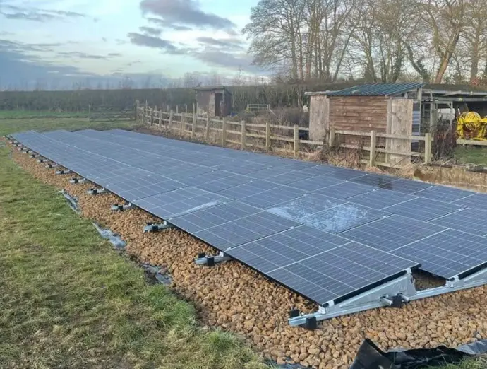 Ground-mounted solar panel system undergoing inspection and maintenance in Greater Manchester