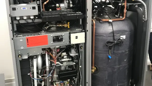 Internal view of heat pump system components installed by The Heating People in Manchester