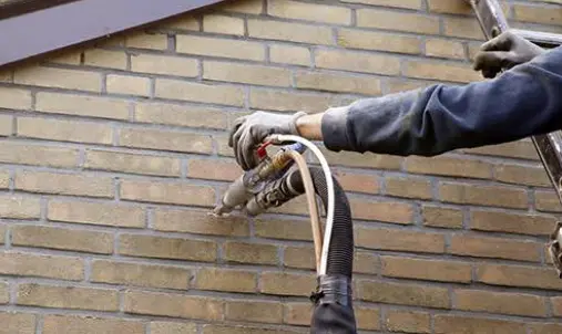 Cavity wall insulation being installed at a Manchester property